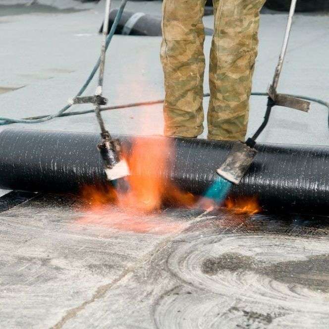 Plat dak branden door dakdekker in Gemert